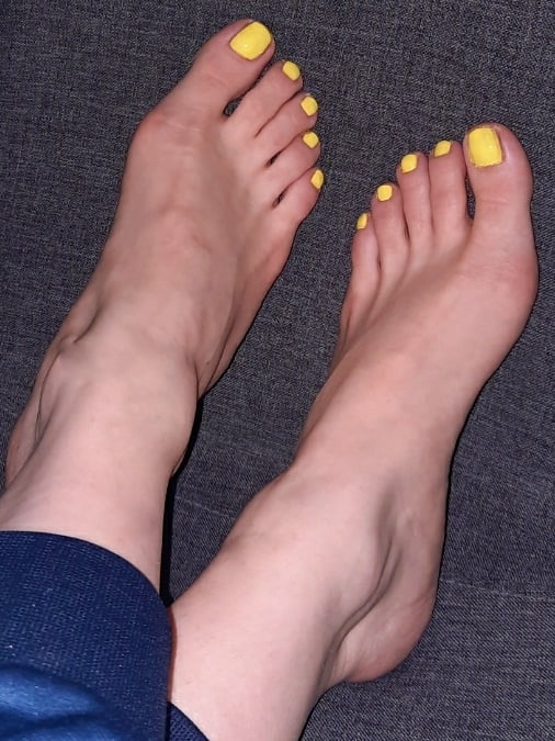 Bare feet, yellow nail polish on her toes - 4 Photos 