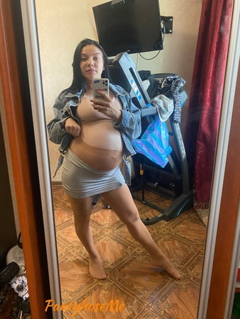 pregnant brunette in sheer pantyhose         