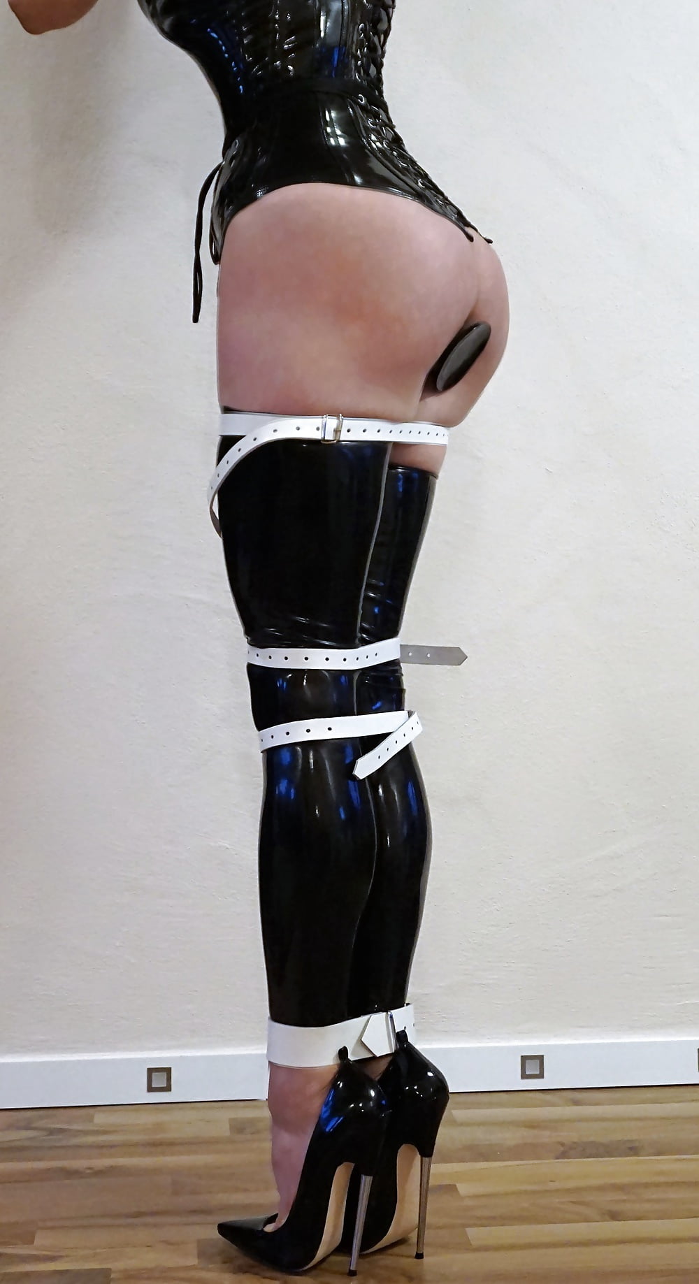 Bondage latex corset slave.