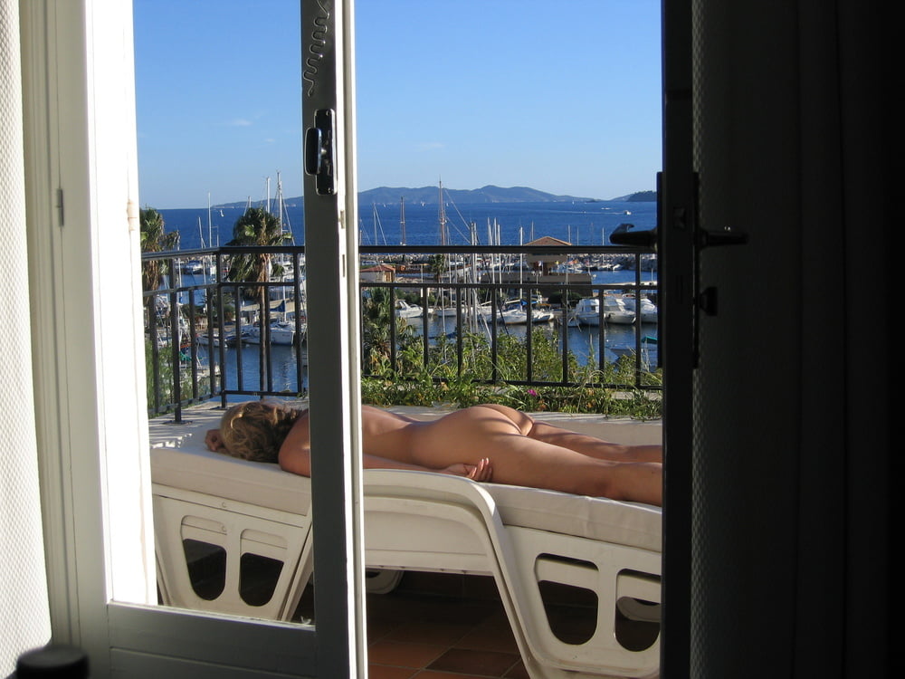 Porn image Milf with big ass suntanning outside on seaside balcony