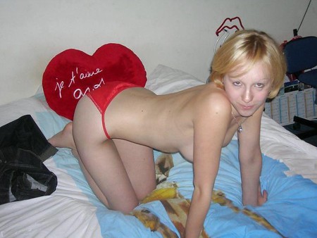 Blonde Cutie posing on her bed