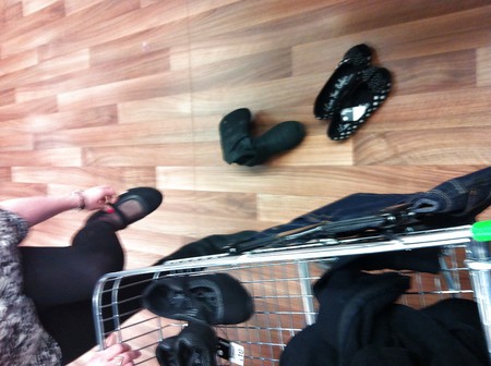 Em trying on shoes in asda, black tights